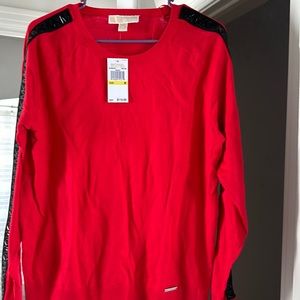 Ladies Red Michael Kors sweater with black embossed trim on sleeves